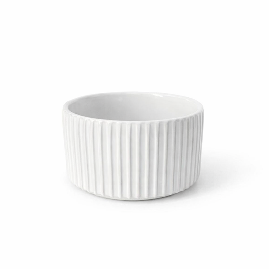 Maceta blanca estriada con líneas verticales, ideal para interiores modernos